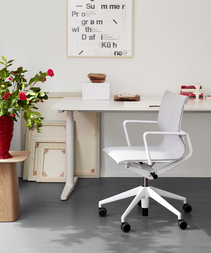 Physix chair by Vitra at a home office desk, finishes in which with a grey mesh fabric seat